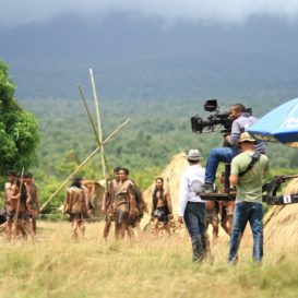 cameraman and director filming a movie in a natural setting