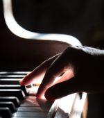fingers touching piano keys