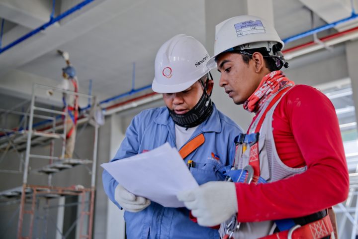 construction manager reviewing plans with a worker