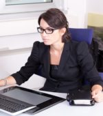 business woman in a suit works on her computer