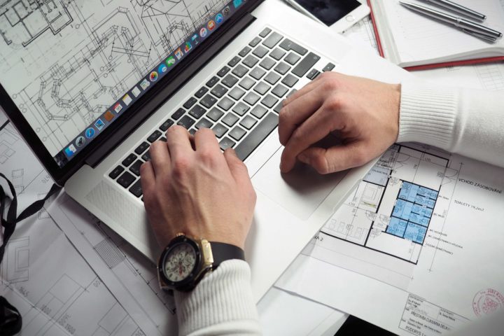 architect working on drafting plans on laptop