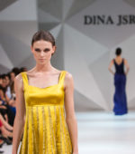 runway model on the catwalk wearing a yellow shift