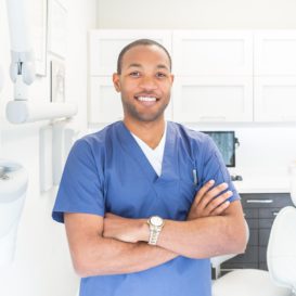 dentist stands in a clean dental examination room