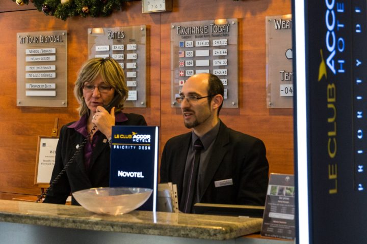 Lodging Management oversees check-in from a hotel front desk