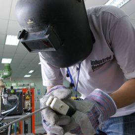 welder wearing protective head gear gets in close