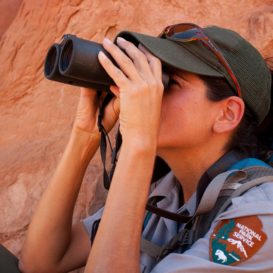 park ranger holds binoculars